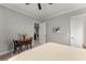 This charming bedroom features an adjacent sitting area and elegant gray walls with white trim at 6455 Quiet Cove Rd, Cumming, GA 30041