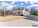 Beautiful white home featuring a spacious driveway and attached two-car garage at 6455 Quiet Cove Rd, Cumming, GA 30041