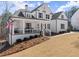 Attractive home with a cozy front porch, well-kept yard, and classic architectural details at 6455 Quiet Cove Rd, Cumming, GA 30041