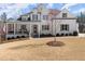 Charming exterior with a welcoming front porch, manicured lawn, and classic curb appeal at 6455 Quiet Cove Rd, Cumming, GA 30041