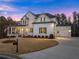 Stylish home features a two-car garage, well-maintained lawn, and charming curb appeal at 6455 Quiet Cove Rd, Cumming, GA 30041