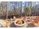 Enjoy evenings by the fire pit surrounded by towering trees and peaceful nature at 6455 Quiet Cove Rd, Cumming, GA 30041