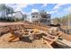 Gather around this stone fire pit with ample seating in a serene backyard setting at 6455 Quiet Cove Rd, Cumming, GA 30041