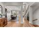 Inviting foyer with hardwood floors leading into an open dining area, staircase, and view of the home's layout at 6455 Quiet Cove Rd, Cumming, GA 30041