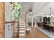 Elegant foyer with hardwood floors, a staircase, and an open view into the dining and living areas at 6455 Quiet Cove Rd, Cumming, GA 30041