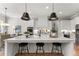 Contemporary kitchen with sleek white cabinets, quartz countertops, stainless steel appliances, and pendant lighting at 6455 Quiet Cove Rd, Cumming, GA 30041
