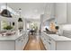 Modern kitchen with white cabinets, subway tile backsplash, and a spacious island with pendant lighting at 6455 Quiet Cove Rd, Cumming, GA 30041