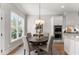 Breakfast nook area with a table near a kitchen with stainless appliances and white cabinets at 6455 Quiet Cove Rd, Cumming, GA 30041