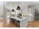 Bright, modern kitchen featuring a large island with seating, hardwood floors and stainless steel appliances at 6455 Quiet Cove Rd, Cumming, GA 30041