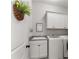 Laundry room with modern appliances, cabinetry for storage and decorative accents at 6455 Quiet Cove Rd, Cumming, GA 30041