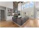 Spacious living room features a stone fireplace, built-in shelves, large windows, and hardwood floors at 6455 Quiet Cove Rd, Cumming, GA 30041