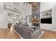 Open-concept living room with a stone fireplace, high ceilings, and a view of the staircase and dining area at 6455 Quiet Cove Rd, Cumming, GA 30041