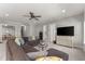Open-concept living room with a large sectional sofa, ceiling fan, and access to other rooms at 6455 Quiet Cove Rd, Cumming, GA 30041