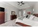 Primary bedroom featuring carpet flooring, tray ceiling, ceiling fan and a dresser at 6455 Quiet Cove Rd, Cumming, GA 30041