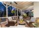 Covered patio with comfortable seating and brick flooring, ideal for outdoor entertaining at 6455 Quiet Cove Rd, Cumming, GA 30041