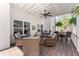 This outdoor porch has brick floors and multiple seating areas for entertaining guests at 6455 Quiet Cove Rd, Cumming, GA 30041
