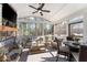 Screened porch with a stone fireplace, multiple seating areas and forest views at 6455 Quiet Cove Rd, Cumming, GA 30041