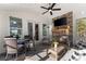 Screened porch with a stone fireplace, multiple seating areas and forest views at 6455 Quiet Cove Rd, Cumming, GA 30041