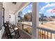 Charming porch with brick flooring and classic rocking chairs, offering a cozy spot to relax and enjoy the neighborhood views at 6455 Quiet Cove Rd, Cumming, GA 30041