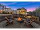 Gorgeous home exterior at dusk, showcasing outdoor living spaces and a cozy fire pit at 6455 Quiet Cove Rd, Cumming, GA 30041