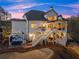 Beautiful home showcasing multiple outdoor living areas, a hot tub, and meticulous landscaping at 6455 Quiet Cove Rd, Cumming, GA 30041