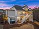 Stunning rear exterior with a walkout basement, hot tub, and expansive outdoor living spaces at 6455 Quiet Cove Rd, Cumming, GA 30041