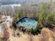 Aerial view of community tennis courts featuring a cabana and mature landscaping at 6455 Quiet Cove Rd, Cumming, GA 30041