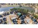 Aerial view of homes with backyard pools in a lakeside community, showcasing neighborhood amenities at 654 Crystal Cove Ct, Loganville, GA 30052