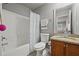This bathroom features a shower-tub combo, single sink vanity, and neutral-toned walls at 654 Crystal Cove Ct, Loganville, GA 30052