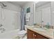 Well-lit bathroom featuring a shower-tub combo, a toilet, and a vanity with a mirror at 654 Crystal Cove Ct, Loganville, GA 30052