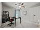 Neutral bedroom featuring a ceiling fan, a desk with an office chair, and plenty of natural light at 654 Crystal Cove Ct, Loganville, GA 30052