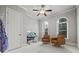 Bedroom with arch windows, neutral walls, plush carpet, and ceiling fan at 654 Crystal Cove Ct, Loganville, GA 30052