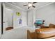 Bedroom featuring neutral walls, plush carpet, ceiling fan and arch windows at 654 Crystal Cove Ct, Loganville, GA 30052
