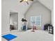 Spacious bonus room featuring exercise equipment with a ceiling fan and bright windows at 654 Crystal Cove Ct, Loganville, GA 30052