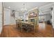 Open concept dining room featuring stone fireplace, hardwood floors, and staircase at 654 Crystal Cove Ct, Loganville, GA 30052