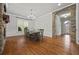 Bright dining room featuring hardwood floors and a stone archway into the foyer at 654 Crystal Cove Ct, Loganville, GA 30052