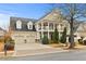 Charming two-story home with a welcoming front porch, manicured landscaping, and a two-car garage at 654 Crystal Cove Ct, Loganville, GA 30052
