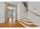 Foyer with hardwood floors, stone archway and staircase featuring wood and iron accents at 654 Crystal Cove Ct, Loganville, GA 30052