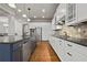 Modern kitchen featuring a blue island, stainless steel appliances, and white cabinetry at 654 Crystal Cove Ct, Loganville, GA 30052
