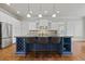 Well-equipped kitchen featuring a blue island with seating and stainless steel appliances at 654 Crystal Cove Ct, Loganville, GA 30052