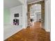 Spacious living room with plush carpeting, stone archway, and an open layout at 654 Crystal Cove Ct, Loganville, GA 30052