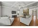Cozy living room featuring hardwood floors, coffered ceiling, and a stone fireplace at 654 Crystal Cove Ct, Loganville, GA 30052