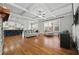 Open concept living room flowing to kitchen with hardwood floors and plenty of natural light at 654 Crystal Cove Ct, Loganville, GA 30052