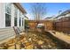 Cozy patio with a built-in gas grill on a brick wall, stone flooring, and a wood fence at 654 Crystal Cove Ct, Loganville, GA 30052