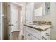 Bathroom features a granite countertop and white vanity with wood style flooring at 1997 Columbia Dr, Decatur, GA 30032