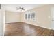 Spacious living room featuring wood-look flooring, ceiling fan and multiple windows at 1997 Columbia Dr, Decatur, GA 30032