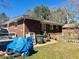 Backyard of a red brick home with a blue tarp and trash cans at 212 Austin Ne Ave, Marietta, GA 30060