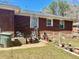 Backyard of brick house with potted plants and green Marietta trash can at 212 Austin Ne Ave, Marietta, GA 30060