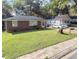 A single-story home with a grassy front yard, a brick facade, and an adjacent house at 212 Austin Ne Ave, Marietta, GA 30060