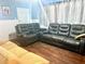 Cozy living room with hardwood floors, a large window, and gray seating, all illuminated by natural light at 212 Austin Ne Ave, Marietta, GA 30060